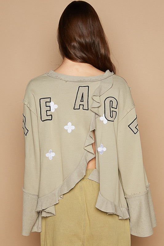 Peace Embroidered Exposed Seam Back Ruffle V-Neck Top